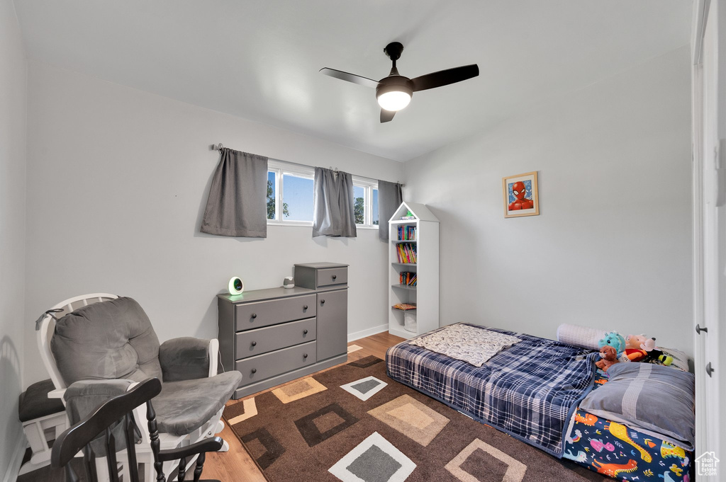 Bedroom with wood finished floors and ceiling fan