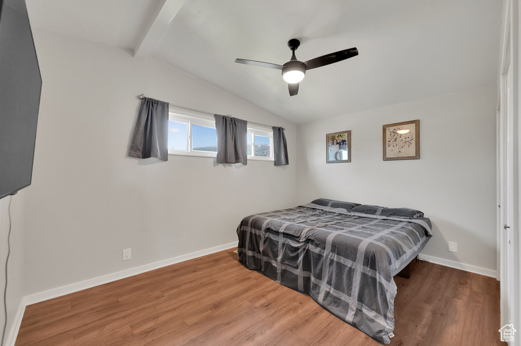 Bedroom with wood finished floors, baseboards, and a ceiling fan