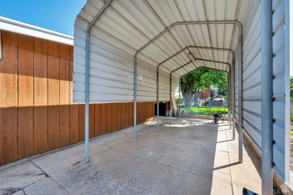 View of parking / parking lot with a carport