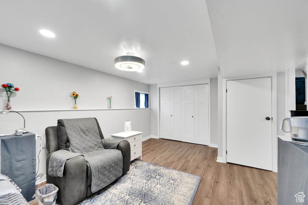 Sitting room with light wood-style floors, recessed lighting, and baseboards