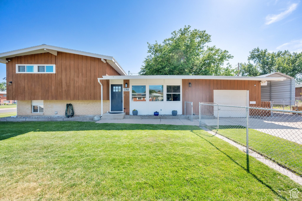 View of front facade featuring entry steps, a garage, concrete driveway, and brick siding