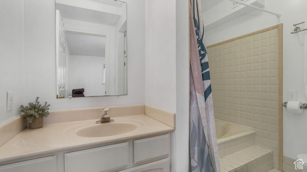 Bathroom with vanity, a shower with curtain, and toilet