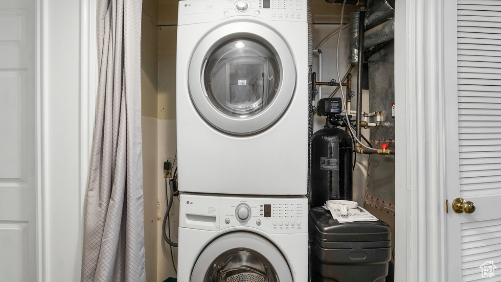 Laundry area featuring stacked washer and clothes dryer