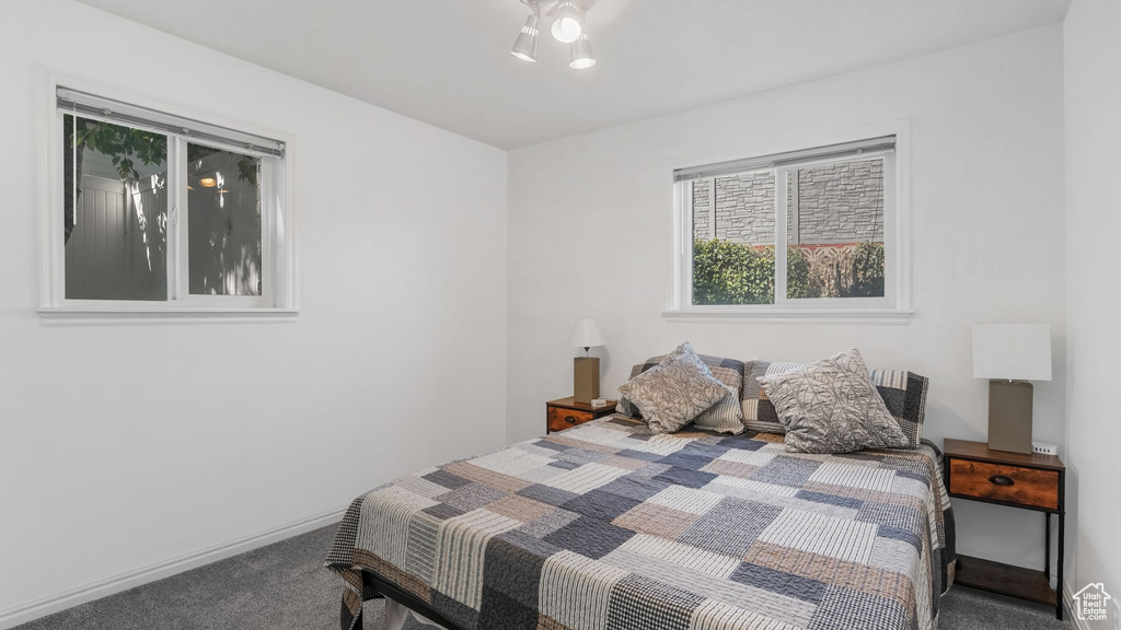 Bedroom featuring carpet flooring and baseboards