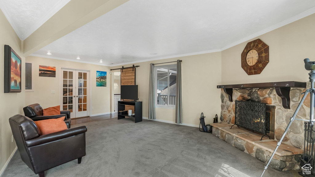 Carpeted living room with french doors, a fireplace, baseboards, ornamental molding, and recessed lighting