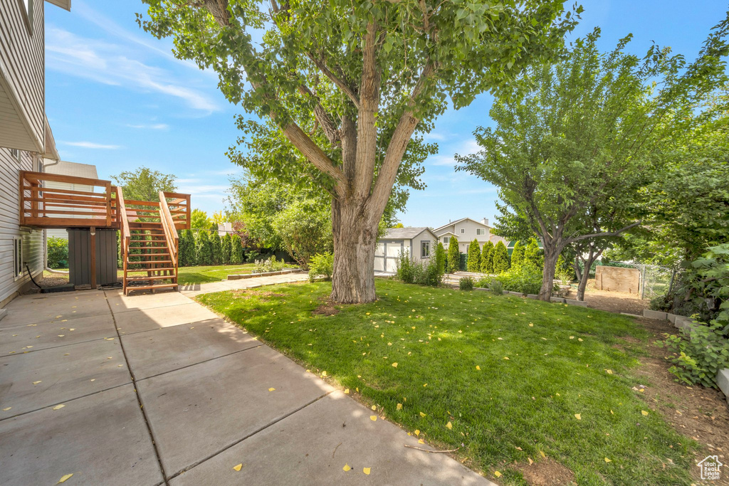 View of yard featuring stairs, a patio area, and a deck