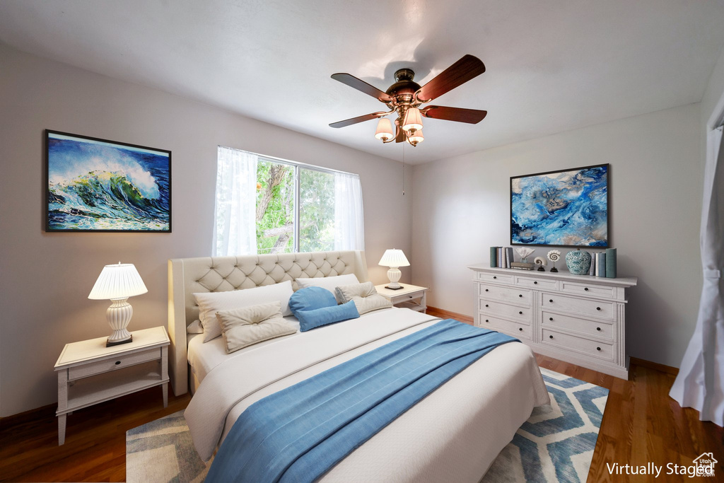 Bedroom with wood finished floors, baseboards, and ceiling fan