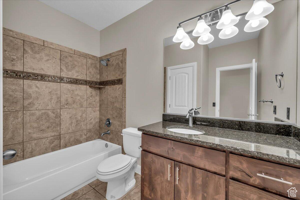 Full bath with toilet, vanity, shower / washtub combination, and tile patterned flooring