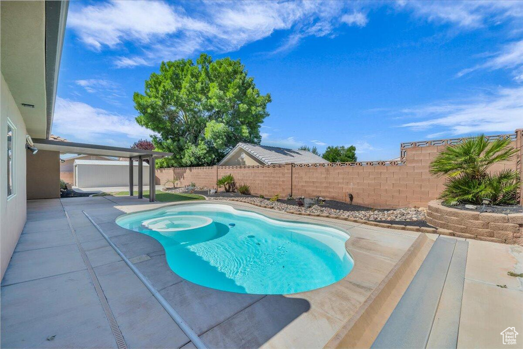 View of pool featuring a patio area and a fenced backyard