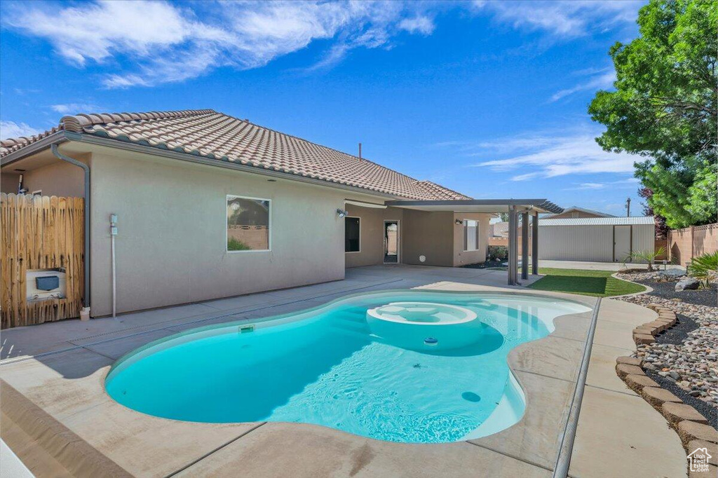 View of pool with a patio and a fenced backyard