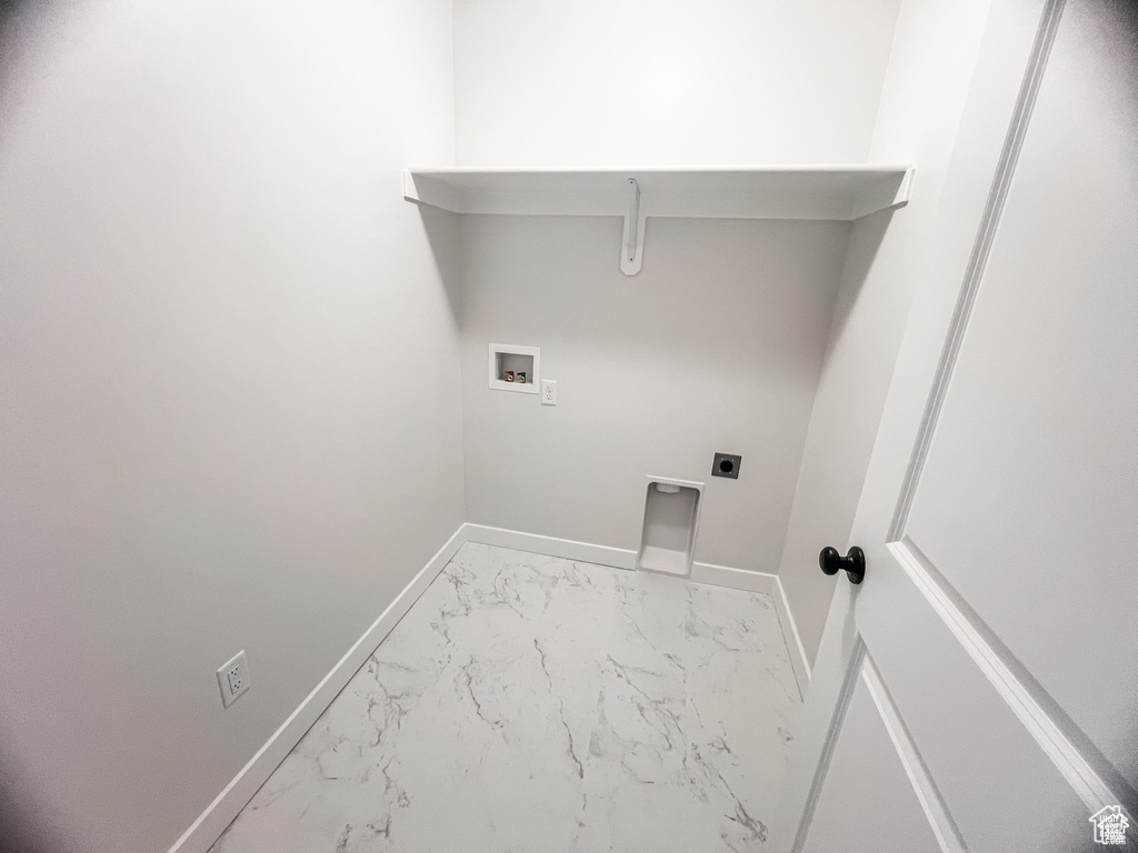 Laundry room with marble finish floors, electric dryer hookup, hookup for a washing machine, and baseboards