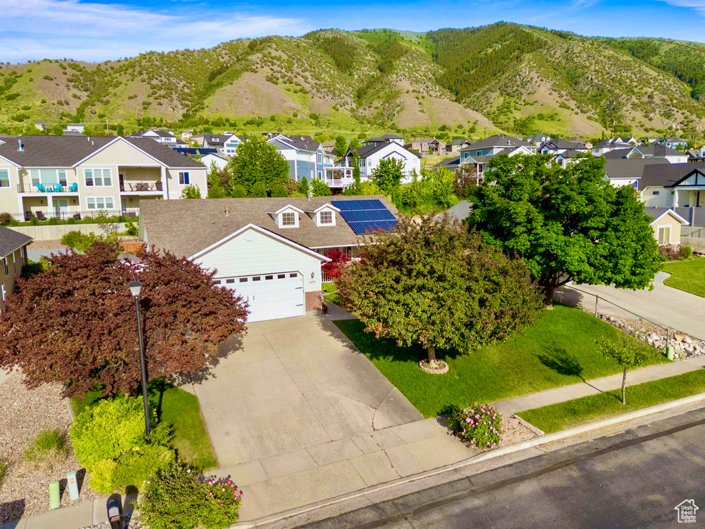 Aerial perspective of suburban area featuring a mountain backdrop