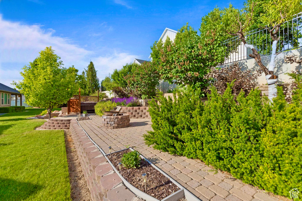 View of green lawn with a patio