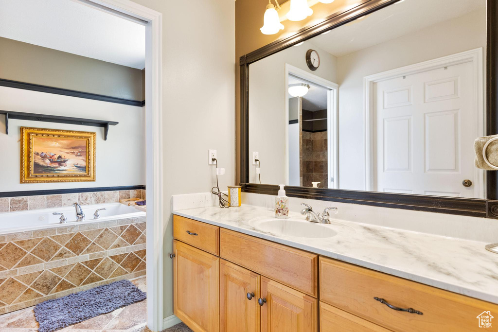 Bathroom featuring vanity and a bath