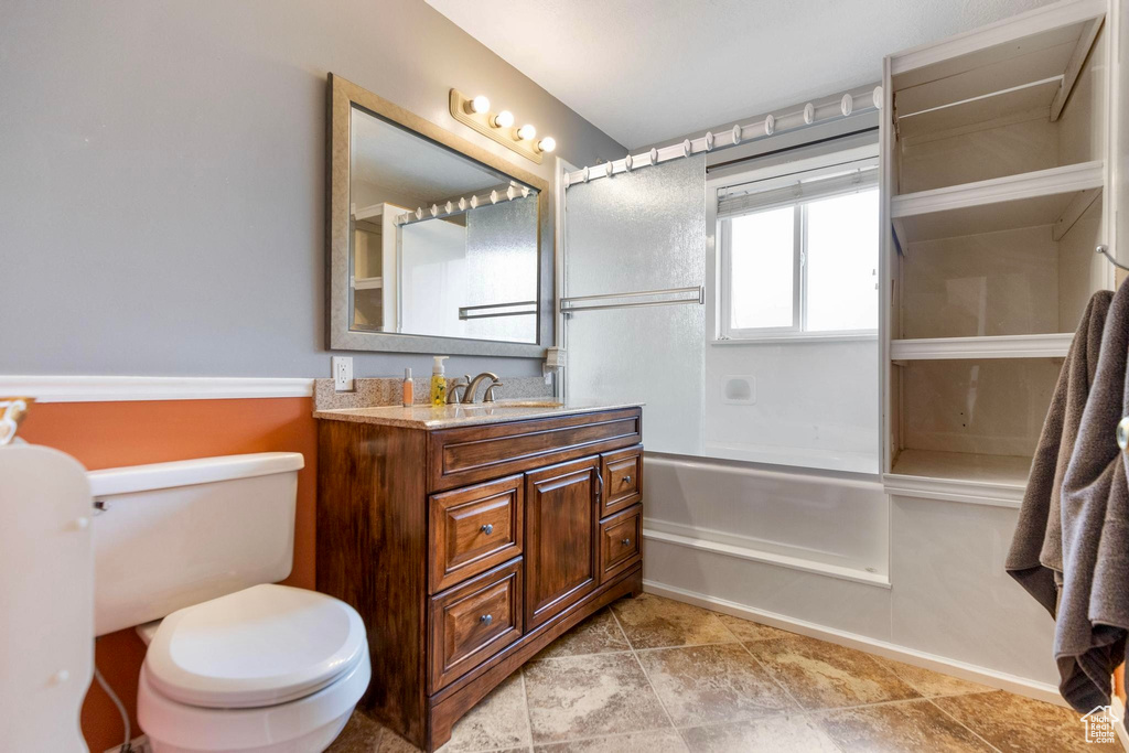 Full bath featuring vanity, bathtub / shower combination, and toilet