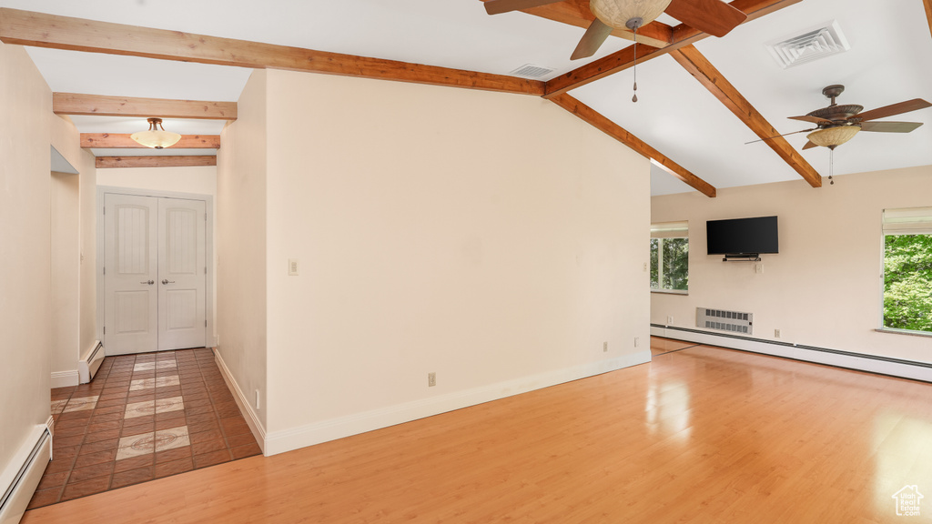 Unfurnished living room with ceiling fan, a baseboard radiator, wood finished floors, and baseboards