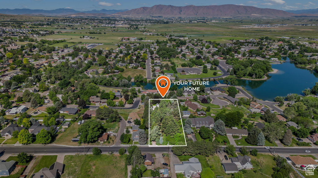 Aerial overview of property\'s location featuring a water and mountain view and property parcel outlined