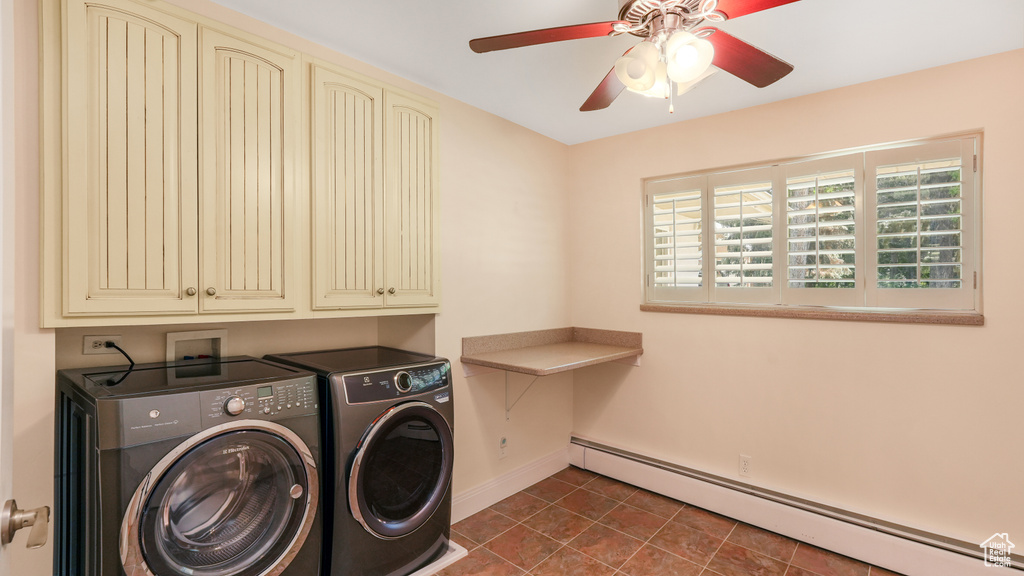Laundry room featuring a baseboard radiator, washer and clothes dryer, cabinet space, baseboards, and ceiling fan