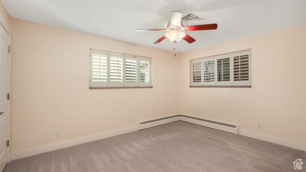 Empty room with a ceiling fan, carpet floors, and baseboards