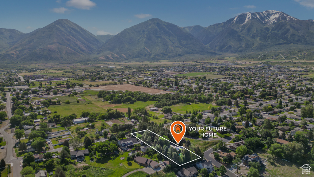 Aerial view of property and surrounding area featuring property boundaries highlighted and mountains