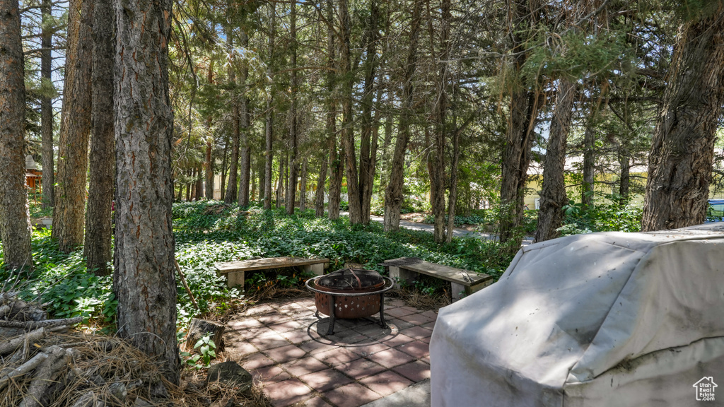 View of patio with an outdoor fire pit