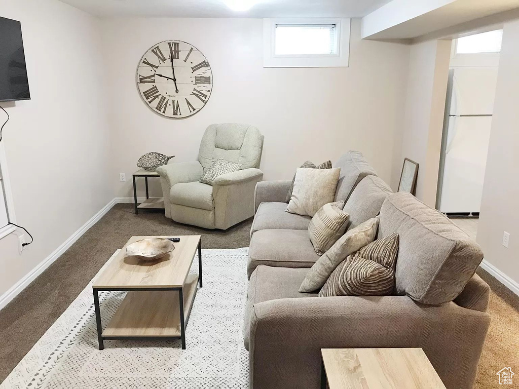 Living area featuring carpet flooring and baseboards