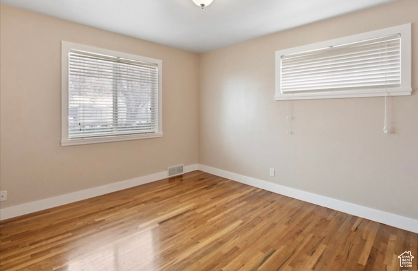 Unfurnished room featuring baseboards and light wood-style floors