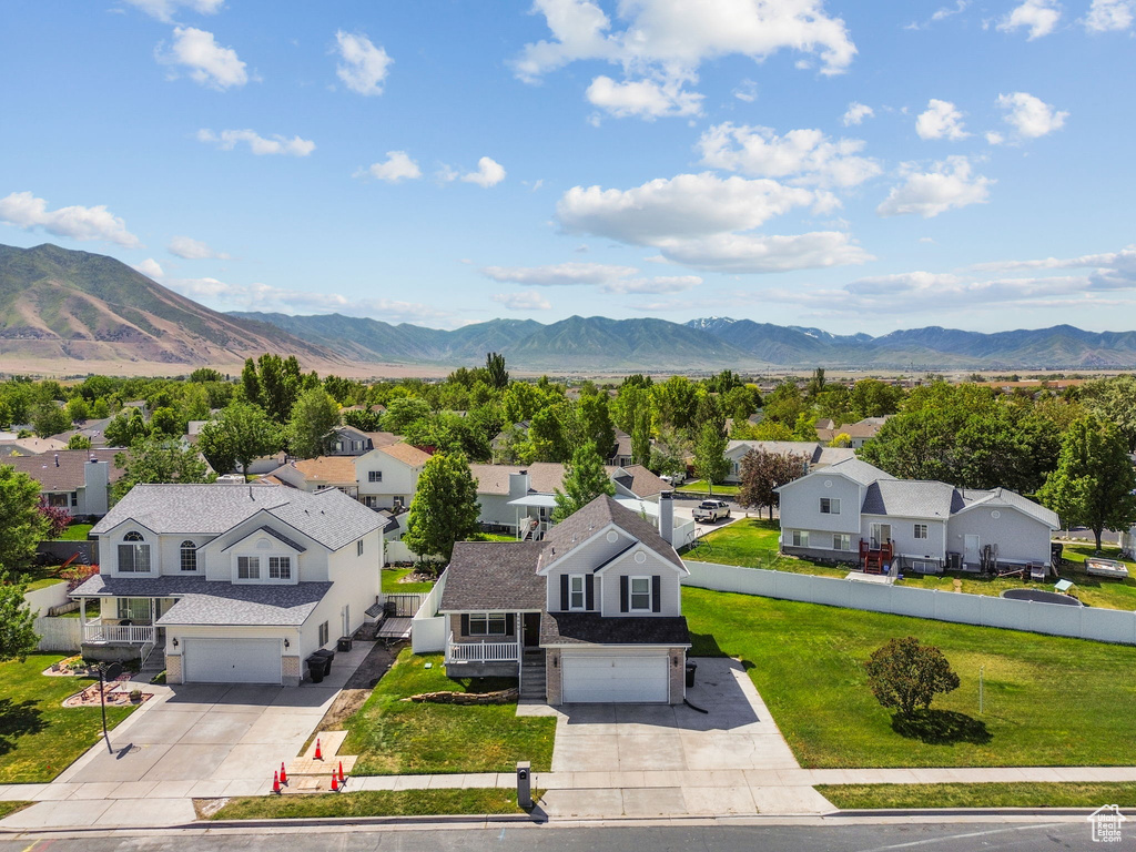 View of mountain backdrop featuring nearby suburban area