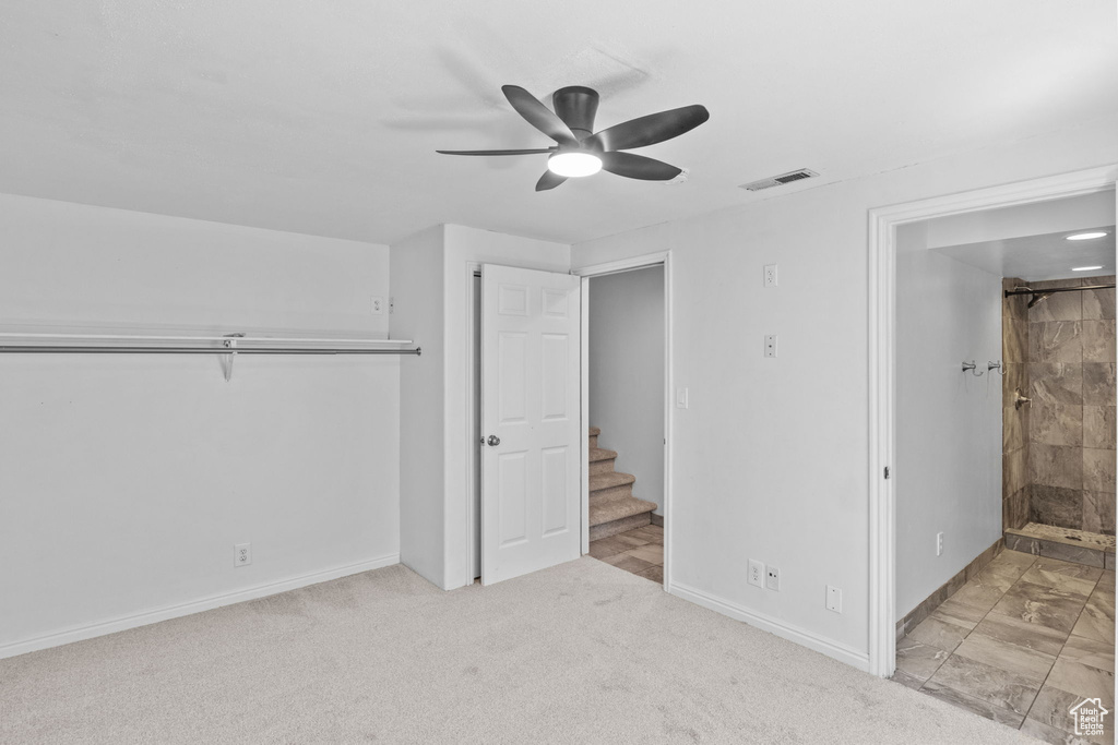 Unfurnished bedroom featuring baseboards, connected bathroom, a ceiling fan, and marble finish floors