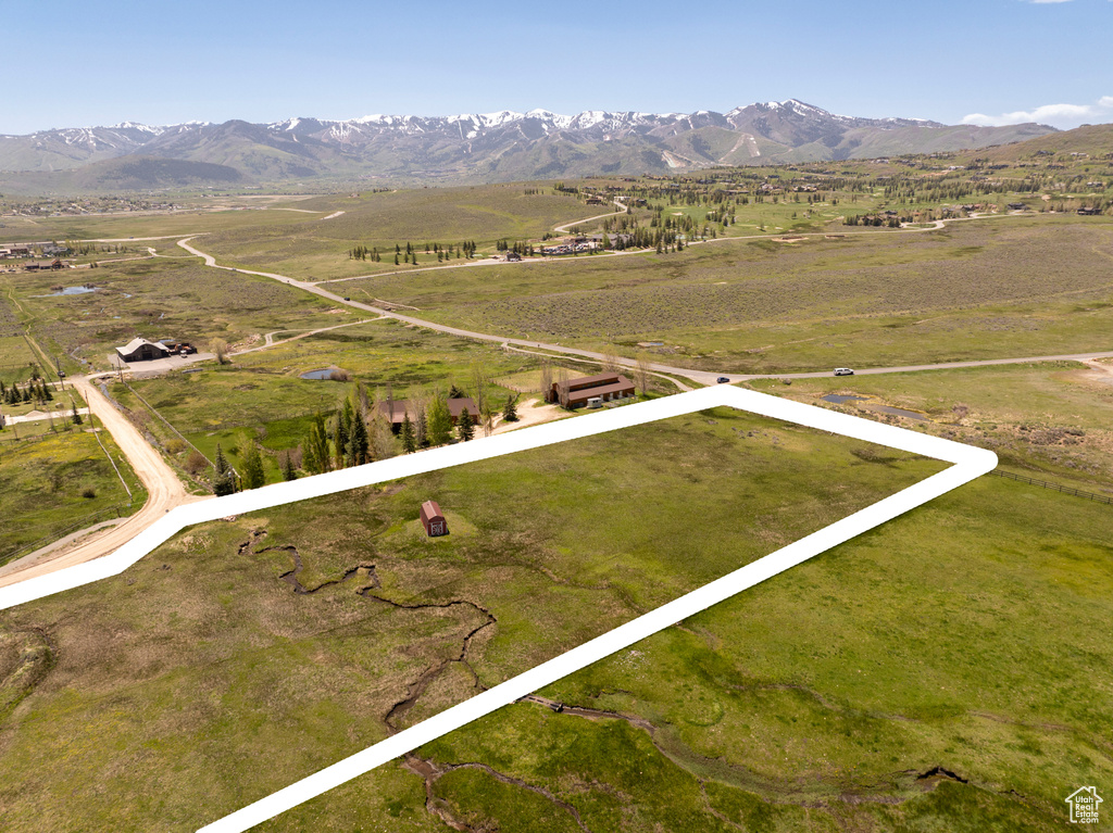 View of rural area with property boundaries highlighted and a mountainous background