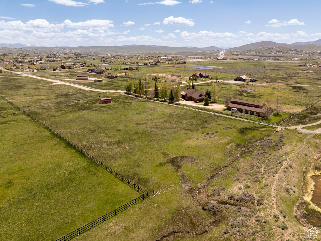 Aerial view of sparsely populated area featuring a mountainous background and a pastoral area