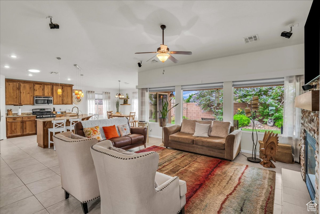 Living area with plenty of natural light, ceiling fan, light tile patterned floors, and recessed lighting