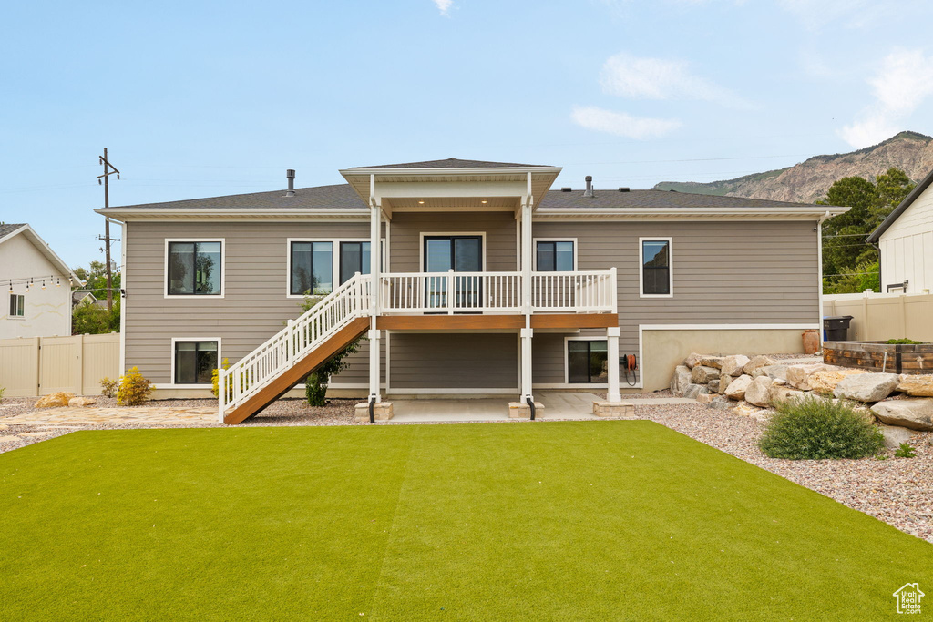Back of property with stairway and a deck
