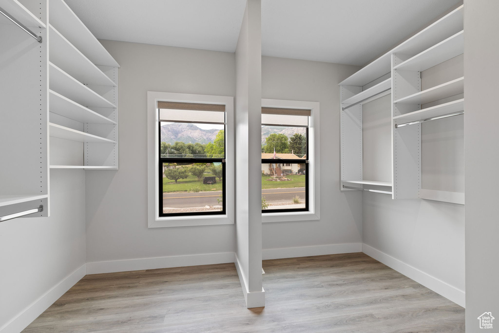 Walk in closet featuring wood finished floors