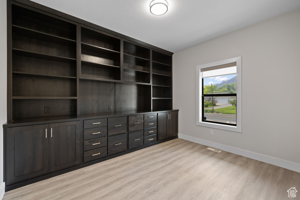 Interior space featuring light wood-style flooring and baseboards