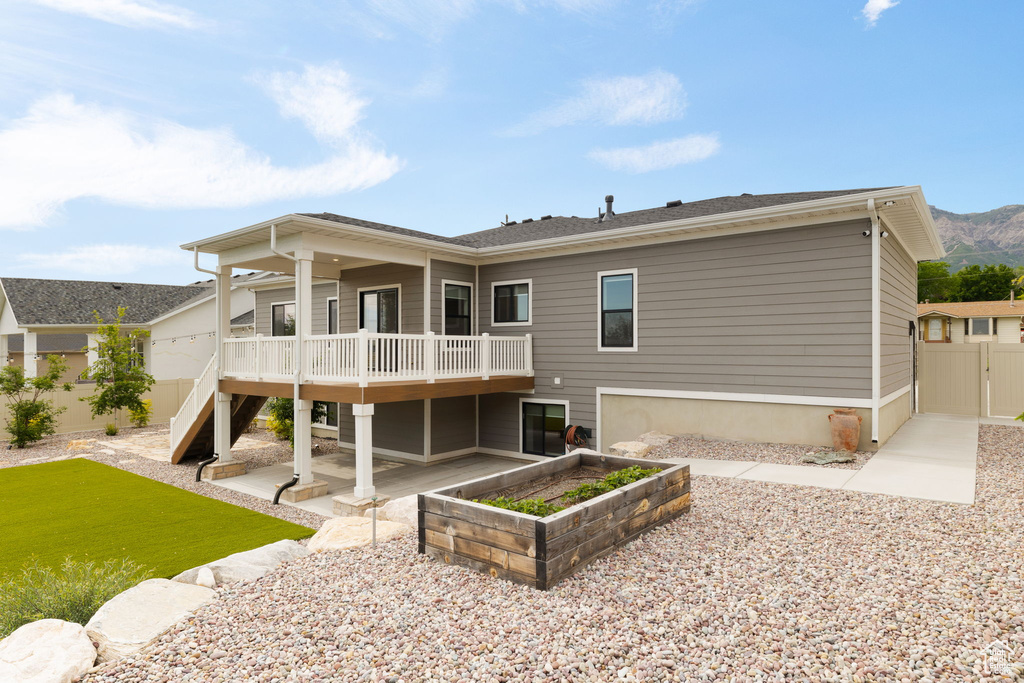 Rear view of house featuring a patio area and a deck