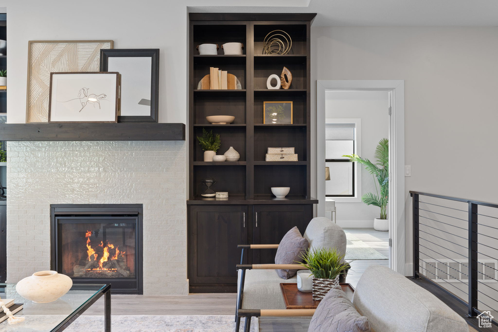 Living room with wood finished floors and a fireplace