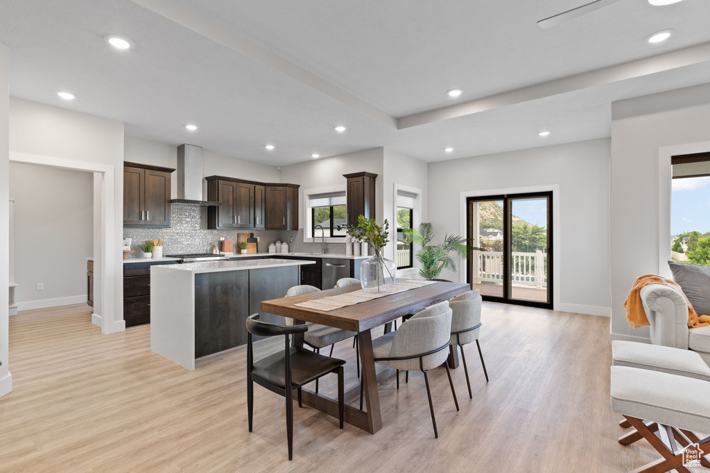 Dining room with recessed lighting, baseboards, and light wood-style floors