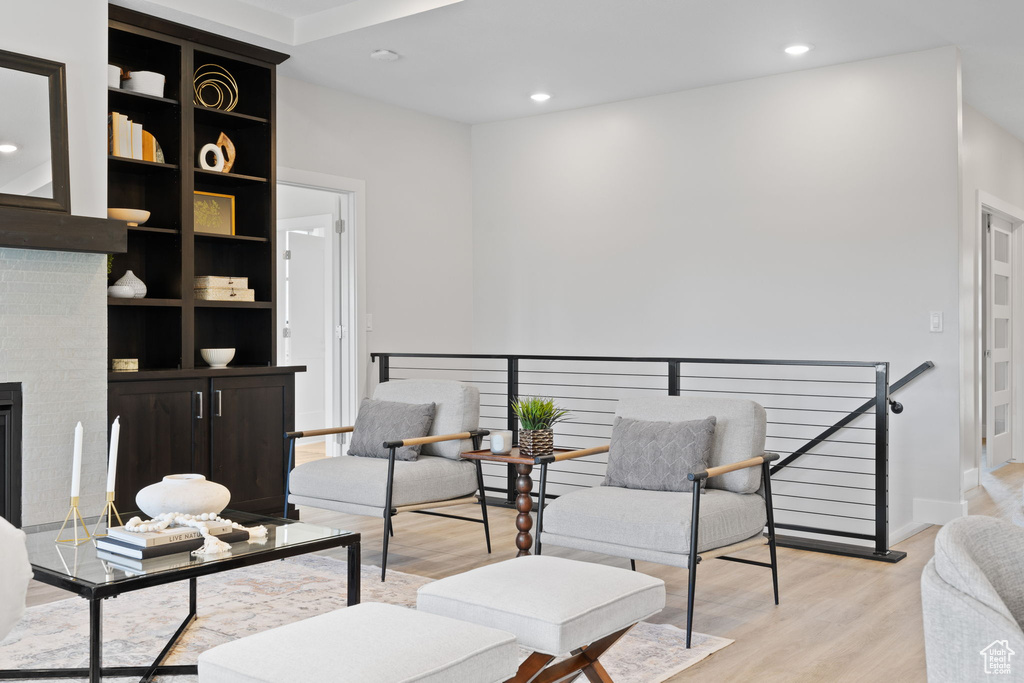 Living area featuring an upstairs landing, light wood-style flooring, recessed lighting, and baseboards