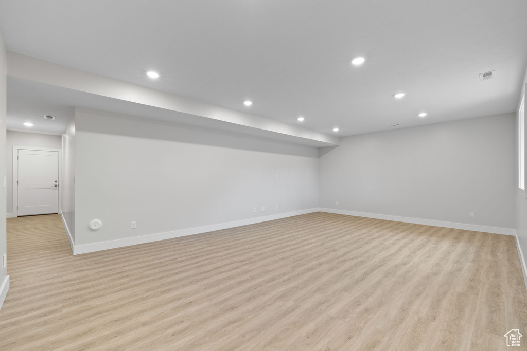Spare room featuring light wood-style floors, recessed lighting, and baseboards