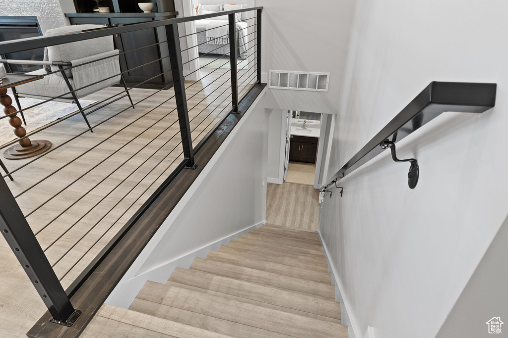 Stairs featuring wood finished floors and baseboards