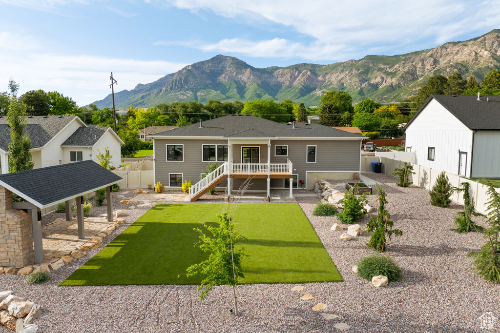 Rear view of property with a deck with mountain view and stairs