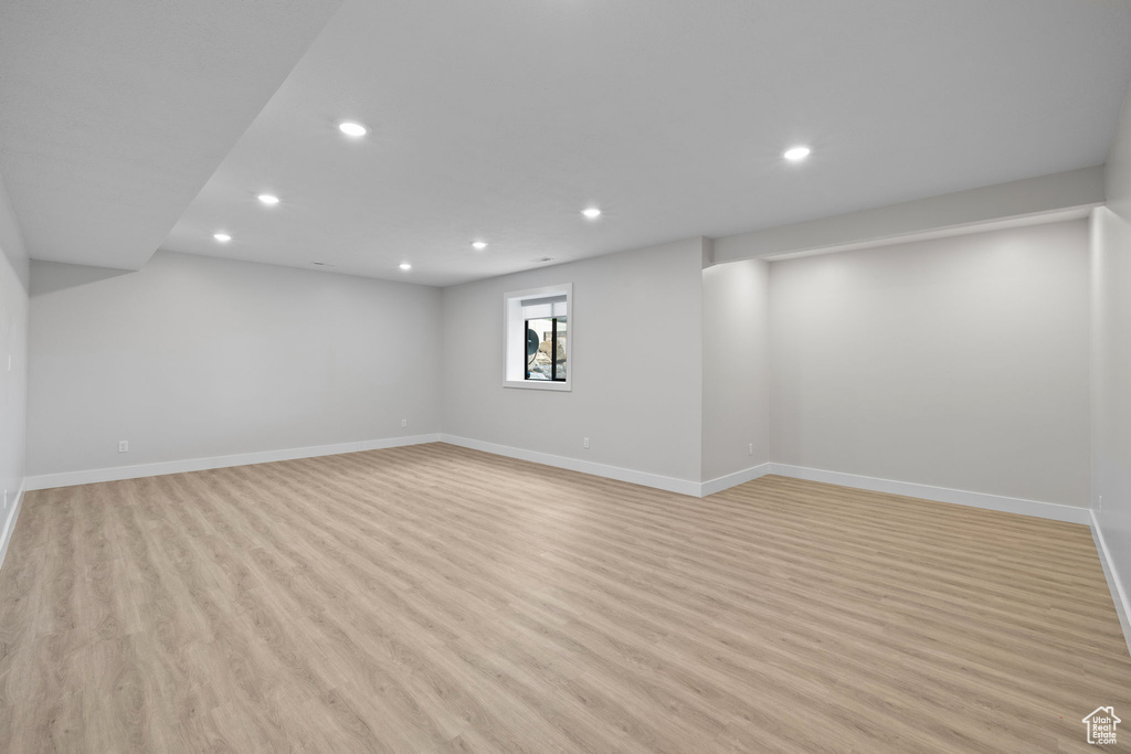 Below grade area featuring recessed lighting, light wood finished floors, and baseboards