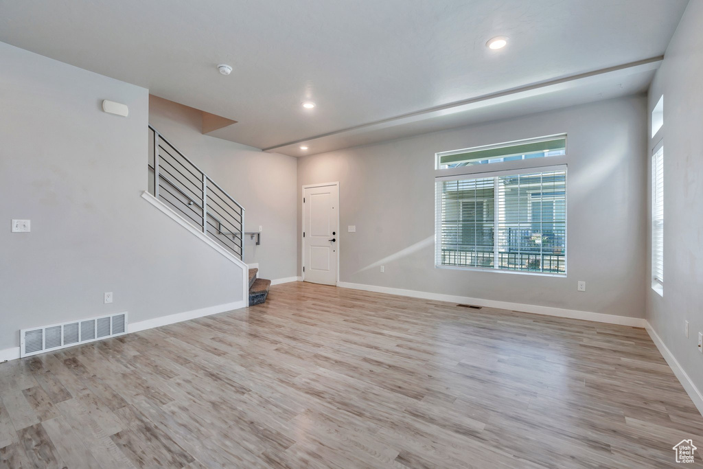 Foyer entrance with plenty of natural light, recessed lighting, wood finished floors, stairs, and baseboards
