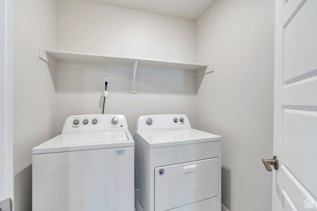 Washroom featuring washing machine and clothes dryer