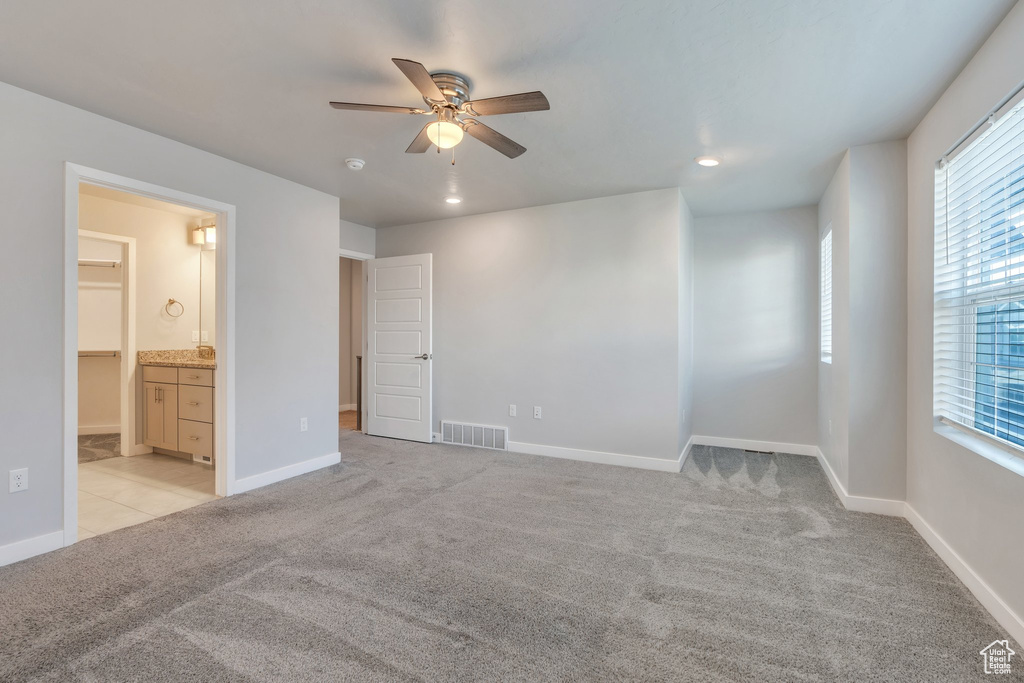 Unfurnished bedroom with light carpet, multiple windows, recessed lighting, and baseboards