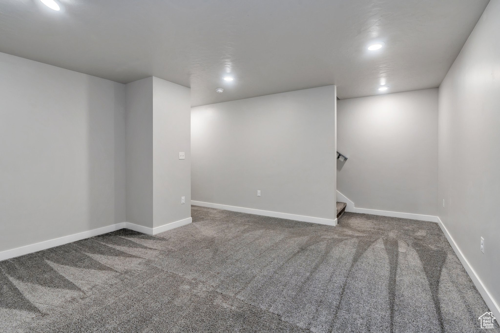 Finished below grade area featuring carpet, recessed lighting, baseboards, and stairs