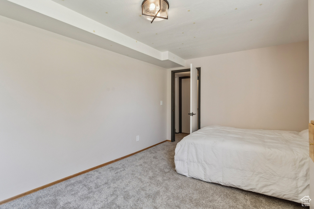Bedroom featuring carpet flooring and baseboards