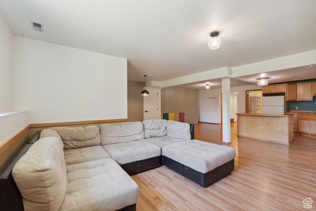 Living area featuring light wood-style flooring and baseboards