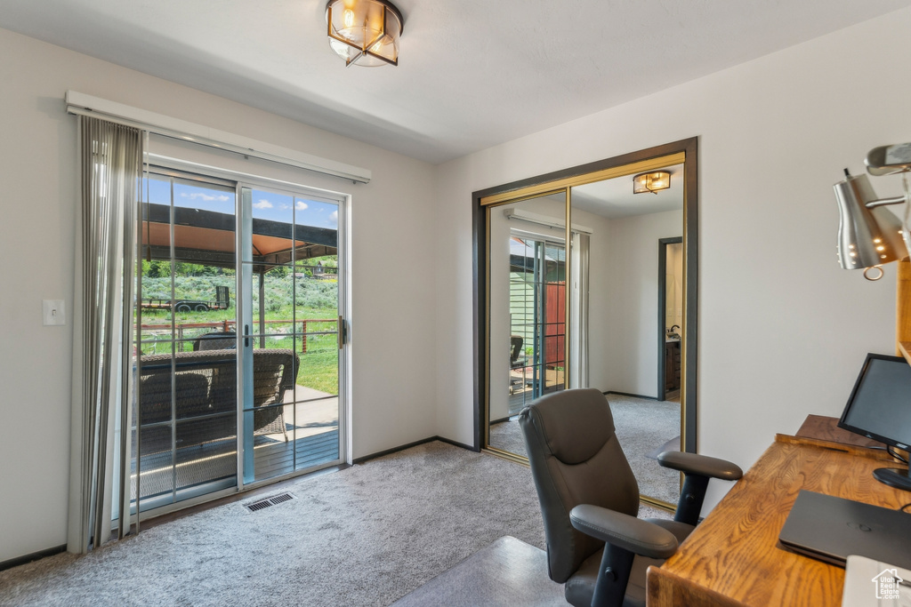 Office with carpet flooring and baseboards